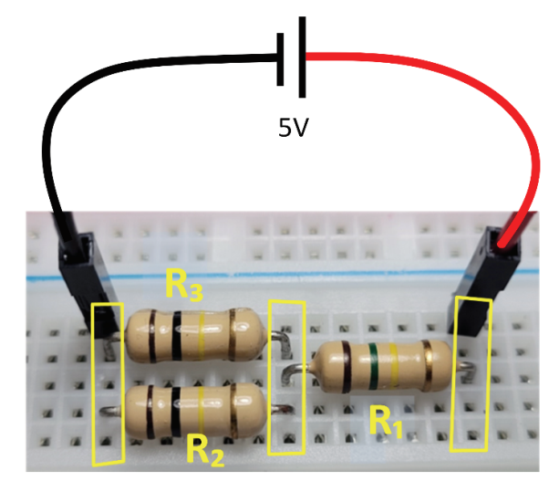 Foto de um circuito com três resistores R1, R2 e R3 montados em uma protoboard, conectados a uma fonte de 5V por cabos vermelho e preto