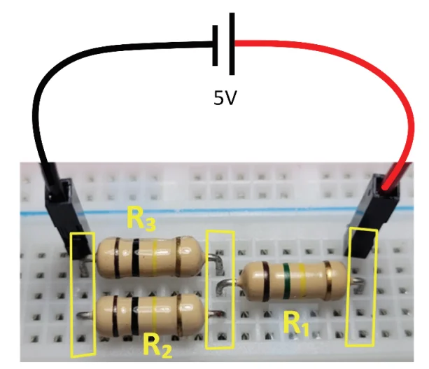 Foto de um circuito com três resistores R1, R2 e R3 montados em uma protoboard, conectados a uma fonte de 5V por cabos vermelho e preto